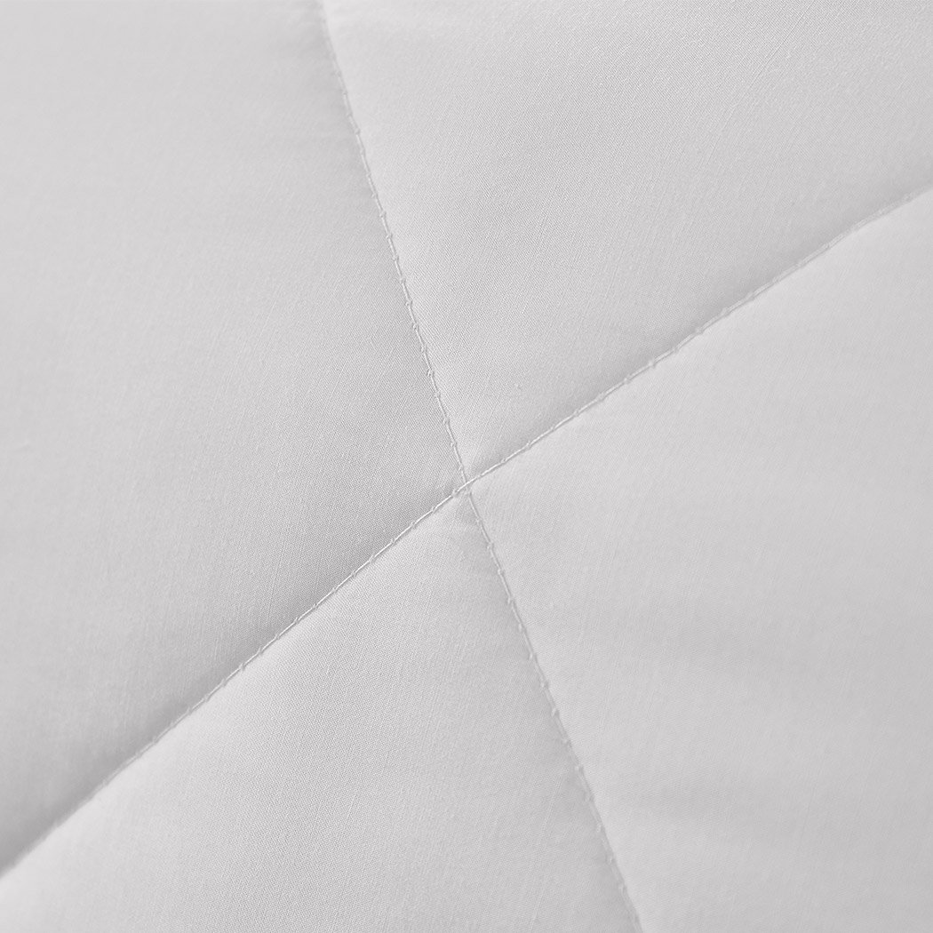 DreamZ 100% Wool Quilt in white, showcasing diamond stitching and soft cotton cover, perfect for all seasons.